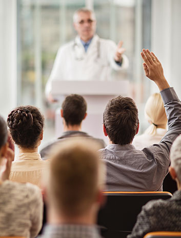 Man raising his hand during a group seminar